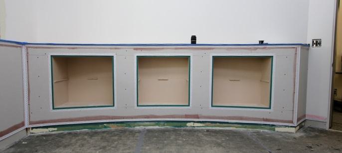 Built in bookshelves and display cases add practical storage solutions to an office. Built in bookshelves and display cases add practical storage solutions to an office.