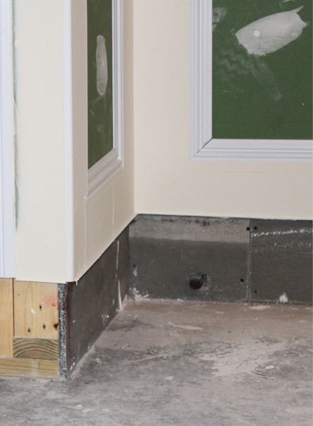 Cement board protects basement drywall from minor flooding. Cement board protects basement drywall from minor flooding.